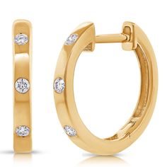 These stunning huggie hoop earrings are crafted in luxurious 14K gold and adorned with brilliant bezel-set diamonds totaling 0.08 carats. Designed to sit comfortably close to the ear, these hoops offer a timeless yet modern style. The sleek gold band showcases each diamond with elegance, making these earrings perfect for both everyday wear and special occasions. Available in 14K white, yellow, or rose gold, they can easily complement any jewelry collection, providing a touch of sparkle and sophi Yellow Gold Diamond Huggie Earrings With Bezel Setting, Classic Bezel Setting Huggie Earrings, Elegant Bezel Set Huggie Hoop Earrings, Diamond Bezel Huggie Earrings, Diamond Huggie Earrings With Bezel Setting For Anniversary, Gold Huggie Earrings With Bezel Setting, Fine Jewelry Bezel-set Huggie Hoop Earrings, Anniversary Huggie Hoop Earrings With Bezel Setting, Anniversary Bezel Set Huggie Hoop Earrings