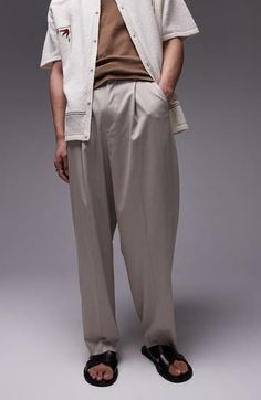 Crisp creases and a pleat front elevate wide-leg pants made with a peck of stretch for comfort. Zip fly with hook-and-bar closure Front slant pockets 69% polyester, 29% viscose, 2% elastane Machine wash, line dry Imported Spring Formal Wide Leg Pants, Tailored Casual Wide Leg Pants, Classic Baggy Dress Pants With Pockets, Casual Wide Leg Pants With Pressed Crease For Spring, Casual Spring Wide Leg Pants With Pressed Crease, Wide Leg Pleated Dress Pants For Spring, Spring Wide Leg Pleated Dress Pants, Spring Wide-leg Pleated Dress Pants, Spring Pleated Wide Leg Dress Pants