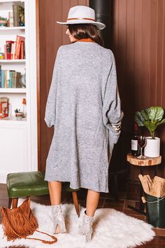 Snuggle up for those crisp fall mornings in this charming grey duster cardigan featuring soft lightweight tight knit material, long oversized bat wing sleeves with fitted cuffs, and an ultra draped open front silhouette hat falls into a straight knee-length hemline! Measurements S-M variant has a Bust of 46", a Hip of 46", a Length of 38", a Sleeve Length of 30", a Waist of 46". M-L variant has a Bust of 48", a Hip of 48", a Length of 39", a Sleeve Length of 30", a Waist of 48". Bat Wing Sleeves, Fall Morning, Wing Sleeves, Autumn Morning, Bat Wing, Duster Cardigan, Oversize Knit, Knitting Materials, Bat Wings