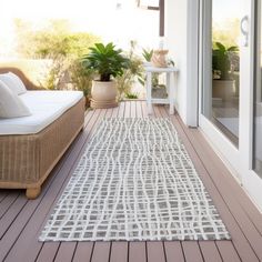 a white rug sitting on top of a wooden floor