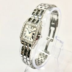 The Cartier Santos Demoiselle Stainless Steel Women's Diamond Watch 20mm 2.25ct is a timeless classic. This Luxurious Cartier watch is pre-owned, in excellent condition, and comes in an original box with a full warranty from ItsHot.com. Whether you're looking for a classic timepiece or a luxurious statement piece, the  Cartier Santos Demoiselle Stainless Steel Women's Diamond Watch 20mm 2.25ct is the perfect choice. Each watch can be additionally customized with diamonds (please contact us for d Elegant Platinum Watch With Polished Finish, Timeless White Gold Diamond Watch With Diamond Accents, Elegant Platinum Watches With Polished Finish, Elegant White Gold Watches With Brilliant Cut, Timeless Platinum Jewelry With Brilliant Cut, Timeless White Gold Diamond Watch With Accents, Elegant Platinum Diamond Watch With Round Dial, Formal White Gold Diamond Watch With Brilliant Cut, Elegant Platinum Diamond Watch