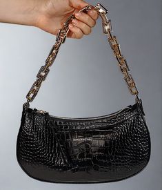 Editor's Notes: This is the must have accessory of the season for those memorable dinner and dancing evenings out on the town. It holds just the right amount of personal items without taking up much space. This handbag is made of croc printed leather with zip top opening and fashionable gold chain handle. Includes a leather strap too. Printed Italian locally sourced leather and hardware Zip top closure One zip interior pocket Two sewn in interior slip pockets Adjustable leather strap Length 11.5 Elegant Baguette Bag With Zipper For Party, Elegant Party Baguette Bag With Zipper Closure, Chic Evening Shoulder Bag With Crocodile Pattern, Luxury Crocodile Pattern Party Shoulder Bag, Top Handbags, Croc Print, Printed Leather, Black Handbags, Zip Top