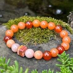 Banded Agate, Sunstone, Carnelian, Orange Calcite and Orange Aventurine handmade gemstone bracelet for good luck, protection and happiness.  Centered by a unique 10mm square banded agate and surrounded by 10mm chunky Boho crystal beads, this bracelet is like a personal force field, protecting from negative energies.  Activating the lower chakras, it grounds in nature's wisdom, freeing courage and creativity and opening the door to abundance and success, with good luck as an added bonus. Name:  Y Adjustable Orange Agate Bracelet, Adjustable Orange Agate Bracelets, Adjustable Carnelian Gemstone Beaded Bracelet, Healing Carnelian Beaded Bracelets With Natural Stones, Healing Carnelian Beaded Bracelets, Spiritual Carnelian Bracelet With Natural Stones, Spiritual Carnelian Gemstone Bracelet, Adjustable Carnelian Beaded Bracelets For Meditation, Spiritual Carnelian Gemstone Beaded Bracelets