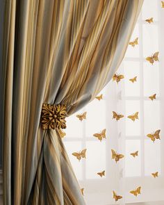 curtains with butterflies on them in front of a window