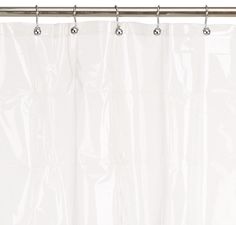 a white shower curtain hanging on a metal rod