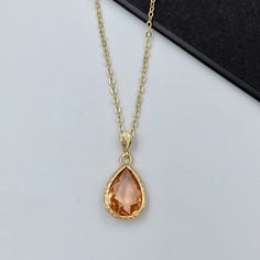 This ochre orange crystal teardrop pendant necklace adds the finishing touch to any outfit. Perfect for yourself, your mom, best friend, bridal party, and more! The pendant frame and chain are made from anti-tarnish gold materials. Measurements: Necklace length is 16" plus 2 inches extender chain for adjustment. Teardrop crystal is 13 mm x 9 mm Comes beautifully packaged in a gift box!  Click here to see more Modern Necklaces: https://www.etsy.com/shop/GrigorevaK?ref=seller-platform-mcnav&sectio Luxury Orange Necklace For Wedding, Orange Necklace Aesthetic, Mom Best Friend, Gold Drop Necklace, Orange Jewelry, Orange Necklace, Orange Stone, Orange Crystals, Jewelry Accessories Ideas