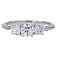 This classic Tiffany & Co. three stone diamond engagement ring features 3 round brilliant cut diamonds all graded as F in color and VS1 / VS2 clarity by Tiffany & Co. The diamonds weigh in total 1.09 carats, and individually weigh .28 carats, .53 carats and .28 carats. The ring is accompanied by the original inside and outside boxes, and valuation report from Tiffany & Co. The ring is a finger size 7 and can be sized up or down. Tiffany Engagement Rings Tiffany & Co., 3 Stone Engagement Rings Round Cut, Timeless Engagement Rings Tiffany & Co., Tiffany Engagement Ring Tiffany & Co., Three Stone Engagement Rings Round, Tiffany Engagement Ring, Brilliant Cut Diamond Ring, Classic Engagement Ring Solitaire, Three Stone Diamond Rings Engagement