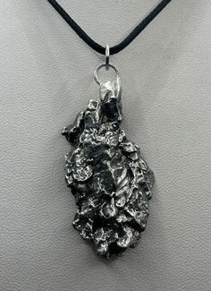 "Rare Meteorite Campo Del Cielo Pendant. This one has such a unique shape with amazing features. The weight is 25.87 grams the meteorite is 1.75\" long and 0.75\" wide. It comes with a complimentary 20\"  sterling silver snake chain or 18\" leather necklace, you choose. The perfect unique gift for those interested in Science-Fi and Space. This meteorite is gorgeous, fully regmaglypted, with no rust! Looks amazing in the sunlight and will be sure to get attention. Free shipping! Time that Meteori Meteorite Necklace, Astronomy Gift, Meteorite Jewelry, Iron Meteorite, Space Gift, Silver Snake Chain, Leather Necklace, Snake Chain, Jewelry Inspo