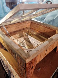 an open wooden box sitting on top of a table