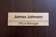 a wooden name plate for a office manager