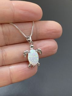 "Small Sterling Silver White Opal Turtle Necklace Dainty and Minimalist Necklace Metal: All Components Are Made From Solid .925 Sterling Silver Stone: Lab created Opal Measurement: pendant is approx. 25mm (0.98\") and 14mm (0.55\") wide You can enter my storefront here https://www.etsy.com/shop/LinksAndStones Please Read Store Policy Before Purchase Thank You For Visiting My Shop NK0011" White Opal Earrings, October Birthstone Jewelry, Small Dangle Earrings, Opal Birthstone, Starburst Earrings, Fire Opal Necklace, Turtle Necklace, Turtle Pendant, Dainty Gold Necklace