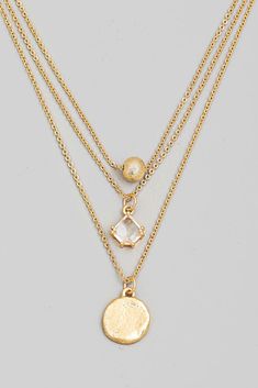 Elevate your look with this unique Layered Chain Disc Charm Necklace! Featuring three layers of chain and a disc charm, this statement piece is 16+2 inches of edgy, modern style. Add a touch of flair to any outfit with this simple yet eye-catching accessory! Affordable Round Brass Charm Necklaces, Trendy Layered Necklace With Delicate Chain, Metal Layered Necklace With Delicate Chain, Layered Metal Necklace With Delicate Chain, Layered Round Necklace With Delicate Chain, Metal Layered Necklace With Round Pendant, Metal Layered Necklace With Delicate Chain And Round Pendant, Trendy Layered Metal Chain Necklace, Layered Necklace With Round Pendant And Adjustable Chain