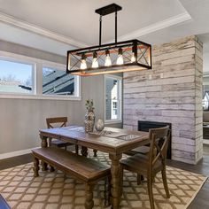 a dining room table and bench in front of a fireplace