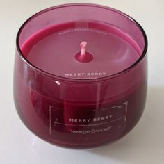 a pink candle sitting on top of a white table