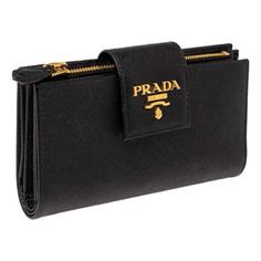 The Prada Saffiano Leather Long Wallet in black is a quintessential accessory that epitomizes luxury and sophistication. Crafted from the brand's signature Saffiano leather, this wallet boasts a distinctive crosshatch texture that not only adds visual appeal but also enhances durability. With its sleek, elongated design, this wallet offers ample space for your essentials. Inside, you'll find multiple card slots, a spacious bill compartment, and a zippered pocket for coins, all thoughtfully organ Leather Long Wallet, Prada Saffiano, Gold Interior, Long Wallet, Cloth Bags, Handbag Accessories, Black And Gold, Card Slots, Slots