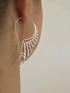 "* Solid Sterling Silver. * Pair of Feather Earrings. * 2.25\" long by 1.25\". Crafted with great detail, depth and dimension, in solid sterling silver, with standard size ear-stems. Inspired by the goddess Artemis, the goddess of the hunt. She is one of the most respected of all the ancient greek deities. Not only was Artemis the goddess of the hunt, she was also known as the goddess of wild animals, wilderness, childbirth, and protector of young children. The huntress earrings were created in Elegant Metal Wing-shaped Earrings, Elegant Wing-shaped Metal Earrings, Silver Art Deco Pierced Earrings, Handmade Silver Art Deco Earrings, Handmade Art Deco Silver Earrings, Elegant Wing-shaped Silver Jewelry, Elegant Silver Wing-shaped Jewelry, Elegant Sterling Silver Jewelry With Unique Design, Art Deco Sterling Silver Dangle Earrings