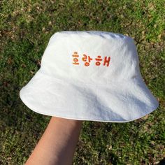 Head size: 23in Orange Cotton Bucket Hat For Summer, Adjustable Orange Cotton Bucket Hat, Summer Orange Cotton Bucket Hat, Orange Cotton Bucket Hat, Casual Adjustable Orange Bucket Hat, Casual Orange Bucket Hat With Short Brim, Casual White Cotton Bucket Hat, Trendy White Bucket Hat For Outdoor, Cute White Cotton Bucket Hat