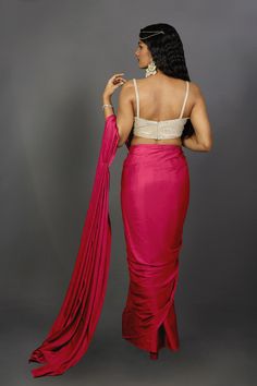 Engage your personality with the luxurious feel of this Satin One Minute Saree in Pink Red dual tone shades. Drape this specially for any festive, party, or wedding occasion.Product Features: Saree Color: Pink & Red Blouse Color: Gold Saree Fabric: Satin Blouse Fabric: Gold Art Silk (For beige metallic blouse choose the fabric option at check out) Work: Ombre Shoulder Drape: Customer must select the shoulder drape style while ordering Occasion: Party , Cocktail Party ,Wedding Reception, Bridesma Red Art Silk Pre-draped Saree With Self Design, Fitted Georgette Pre-draped Saree For Party, Pre-draped Tissue Silk Saree With Dupatta For Party, Elegant Fitted Pre-draped Saree For Navratri, Silk Pre-draped Saree With Dupatta For Party, Evening Semi-stitched Traditional Wear For Navratri, Party Floor-length Art Silk Pre-draped Saree, Fitted Pre-draped Saree With Zari Work For Wedding, Traditional Pre-draped Saree For Festive Party