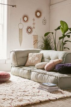 a living room filled with furniture and lots of plants