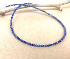 A minimalist necklace made with rich blue beads of genuine lapis lazuli. These AAA quality stones measure 2mm in diameter, and they are round with multifaceted cuts that give them a little extra shimmer in the light. There is a small silver bead at each end, and this connects with a sterling silver lobster claw clasp in the back. Available in a variety of lengths, and comes packaged in a small gift box for you. Ships in 1 business day, via USPS ground advantage.