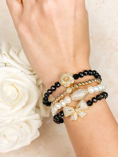 INTENTION: Elegance, Power, Protection MATERIALS: Ribbon Charm: Gold Vermeil (thick 18K gold over sterling silver) and CZ crystals Black Onyx: 6mm round faceted beads Wrist Stretches, Crystals Black, Elegant Bracelet, Pave Ring, Elastic Bracelet, Metal Bracelets, Jewelry Pouch, Faceted Bead, Meaningful Gifts