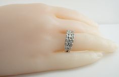 Genuine Diamond Ring, April Birthstone, Vintage Ring, 14K White Gold Band, Gold Ring, Natural Diamond Band, Engagement Ring, Wedding Ring, This adorable estate ring is crafted in solid 14K White Gold. 9 center round brilliant cut diamonds graduate in size and total 1.07 carats. They are VS2-SI2 clarity and H color. 32 smaller diamonds total .32 carat of SI1 clarity and HI color. The total diamond weight for the ring is 1.39 carats. The top measures 7mm North-South. Size 7 (sizable). The ring wei Moissanite Diamond Ring With Diamond Accents For Marriage, Moissanite Ring With Diamond Accents For Marriage, Diamond White Round Cut Diamond Ring For Marriage, Marriage Diamond White Diamond Ring With Center Stone, Diamond White Channel Set Diamond Ring, Fine Jewelry Channel Set Round Diamond Ring, Fine Jewelry Channel Set Diamond Ring, Channel Set Diamond Ring In Diamond White, Fine Jewelry Diamond Ring With Channel Set