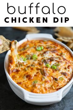 a cheesy dip with green onions and cheese in a white casserole dish