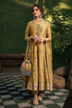 Yellow base anarkali with all over floral bloom prints and pleated flare. Paired with coordinating pant and dupatta with lace border. - Aza Fashions Anarkali Palazzo Set With Floral Print And Traditional Drape, Eid Silk Anarkali Set With Floral Print, Navratri Floral Anarkali Set With Traditional Drape, Navratri Anarkali Set With Floral Print, Silk Anarkali Kurta With Floral Print, Anarkali Style Semi-stitched Floral Sharara, Yellow Floral Print Kurta For Wedding, Designer Semi-stitched Floral Anarkali Set, Silk Anarkali Set With Floral Print