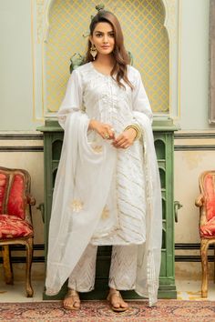 White-gold long kurta with chevron pattern lehirya gota detailing on the neckline, sleeves - hemline and potli buttons. Comes with sheer kota doria dupatta with handwork gota motifs and straight fit cotton pants enhanced with gota work.
Component: 3
Embroidered
Neckline: Round
Sleeve Length: Long
Fabric: Cotton, Kota Doria
Color: White
Potli buttons
Chevron pattern
Side slits
Cutwork trims - Aza Fashions Palazzo Kurta, Long Kurta, Gota Work, White Kurta, Straight Fit Pants, Embroidered Neckline, Indian Fashion Designers, Pernia Pop Up Shop, Fashion App