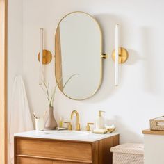 a bathroom with a sink, mirror and towel rack