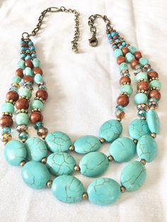 Vintage multi strand turquoise howlite chocker necklace for southwest, cowgirl, boho or just casual style. 3 strands of flattened oval stones mixed with bronze, silver and crystals.  Measures 16 inches with a 4 inch extender chain Excellent preowned condition Cheap Southwestern Style Multicolor Necklaces, Southwestern Multi-strand Beaded Necklaces, Southwestern Multi-strand Adjustable Beaded Necklaces, Adjustable Turquoise Beaded Bib Necklace, Southwestern Multi-strand Beaded Necklace, Adjustable Multi-strand Turquoise Beaded Necklace, Bohemian Adjustable Layered Choker Necklace, Adjustable Bohemian Layered Choker Necklace, Southwestern Multi-strand Turquoise Necklace For Jewelry Making