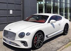 a white car parked in front of a building