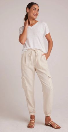 Introducing our versatile Isla Pleated Jogger, designed for both style and comfort, these pants are perfect for everyday wear, offering a comfortable fit that can be worn anywhere. Upgrade your wardrobe with these must-have cargo pants that combine fashion and practicality effortlessly. 50% Cotton 25% Tencel 25% Linen. Summer Versatile Cargo Pants, Chic Summer Cargo Pants For Loungewear, Summer Versatile Cargo Pants With Loosely Fitted Hips, Versatile Summer Cargo Pants With Loosely Fitted Hips, Casual Beige Parachute Pants For Loungewear, Utility Linen Cargo Pants With Cargo Pockets, Relaxed Everyday Bottoms With Side Pockets, Neutral Tapered Leg Bottoms With Pockets, Spring Tapered Leg Joggers With Cargo Pockets