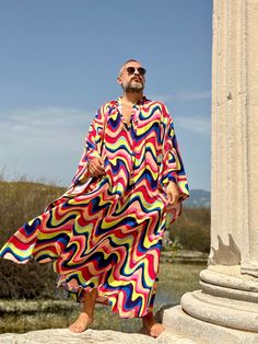 Handmade From start to finish boho wedding kaftan viscose fabric  Men's  caftan Ponchos Billowy dress Unique design rainbow color , multicolor geometric print from Small to 7XL size options Plus size Feel free to Ask for custom made custom made hemline  Gift for him Super comfortable men's clothing  to wear at home or outdoor Comfortable and chic For my all caftans and robes shop link: www.etsy.com/shop/mnouss/ worldwide fast shipping And my new shop link- caftan and more-  www.etsy.com/shop/mai Oversized Multicolor Kaftan For Vacation, Multicolor Long Sleeve Kaftan For Beachwear, Long Sleeve Multicolor Kaftan For Vacation, Oversized Long Sleeve Kaftan For Beachwear, Multicolor Long Thobe For Summer, Summer Oversized Thobe In Tunic Style, Bohemian Multicolor Thobe For Festivals, Oversized Tunic Kaftan For Festivals, Bohemian Multicolor Summer Thobe