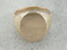 "What a perfect signet ring! We love the way that the undercarriage of this ring is hidden. The design creates the look of a weighty, heavy ring, but in fact this is an easy to wear piece, with an affordable price point thanks to the lattice work undercarriage! Market Square Jewelers works with one of the finest hand engravers in the northeast. With over 30 years of experience, our engraver hand carves lettering, monograms, crests, or patterns in period-specific styles. Choose from our many mono Antique Oval Signet Ring With Diamond Cut, Fine Jewelry Oval Diamond Cut Signet Ring, Heirloom Style Open Signet Ring With Diamond Cut, Oval Diamond Cut Signet Ring, Wedding Wide Band Signet Ring In Fine Jewelry Style, Oval Diamond Cut Signet Ring For Formal Occasions, Formal Oval Diamond Cut Signet Ring, Oval Engraved Wedding Ring With Polished Finish, Heirloom Signet Ring With Diamond Cut