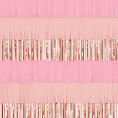 a pink and gold striped wallpaper with metallic foil fringes on the bottom half