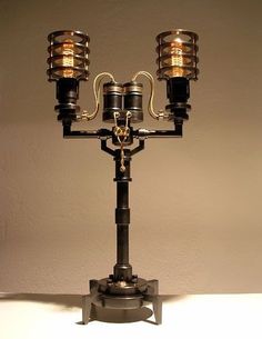 a metal candelabra sitting on top of a white table next to a wall