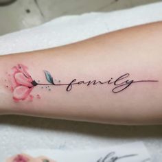 a woman's arm with the word family written on it and a pink flower