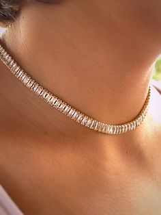 "\"18k Gold Plated Brass Tennis Choker with Cubic Zirconia, 15-3/4 inch (40 cm)\" Description: Elevate your accessory game with our exquisite tennis choker, crafted from high-quality brass and lavishly plated in 18k gold. This stunning piece is adorned with brilliantly sparkling cubic zirconia, set in a classic tennis style that wraps elegantly around the neck. At a length of 15-3/4 inches (40 cm), this choker is designed to offer a snug yet comfortable fit, making it an ideal choice for both everyday elegance and special occasions. The harmonious blend of the cubic zirconia's sparkle with the warm hue of the gold plating creates a sophisticated and timeless look. This tennis choker is not just a piece of jewelry; it's an expression of refined taste and luxury. Whether you're looking to ad Luxury Gold Plated Timeless Diamond Necklace, Luxury Yellow Gold Party Choker, Luxury Gold Tennis Necklace With Prong Setting, Luxury Round Yellow Gold Tennis Necklace, Gold Tennis Necklace With Clavicle Chain For Party, Gold Clavicle Chain Tennis Necklace For Party, Gold Cubic Zirconia Tennis Necklace For Party, Gold Cubic Zirconia Bridal Choker, Gold Crystal Choker With Clavicle Chain