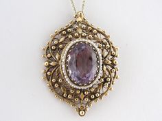 Perfectly faceted to bring out the deep purple flashes within the medium color stone, this beauty is set in a vintage setting that is versatile enough to wear as a pin or pendant. Small seed pearls strung on wire have a wonderful soft quality, and their round shape echoes the filigree and beadwork style of the pendant. Stone: Amethyst, Measures 18 x 13 mm Oval, Accent: Seed Pearls on Wire Metal: 14K Yellow Gold Measures: 48 x 35 mm Time Period: Vintage Frame with New Amethyst SKU #: 6YF26K-P Eac Marco Vintage, Vintage Setting, Amethyst Gem, Vintage Frame, Color Stone, Seed Pearl, Vintage Frames, Eternity Bands, Deep Purple