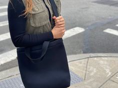 You are going to love our Town Bag! A chic, easy-to-wear crossbody perfect for carrying your daily essentials! Seriously tricked out with an inside slip pocket. It has a hearty snap at the top. Carry it by the handles or wear it as a crossbody for extra support. This is the perfect bag for everyday, on-the-go!Features: Zipper Compartment, Inner Slip Pocket, Snap Closure, Comfort Handles, Adjustable Crossbody Strap, 15" x 13" x 3".Details• Made in United States• Style: QK-TOWN-NBLACK Versatile Everyday Shoulder Bag With Cell Phone Pocket, Versatile Shoulder Bag With Cell Phone Pocket, Casual Satchel With Removable Pouch For On-the-go, Chic Everyday Bags With Cell Phone Pocket, Chic Everyday Bag With Cell Phone Pocket, Versatile Bags With Cell Phone Pocket For Everyday Use, Casual Satchel With Removable Pouch, Fall Bags With Cell Phone Pocket For On-the-go, Casual Satchel With Removable Pouch For Everyday