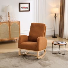 a living room with a rocking chair and side table