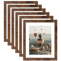 four wooden frames with hot air balloons in the sky