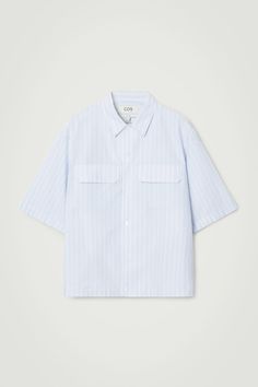 Borrowing from classic workwear, this pinstriped shirt is designed with short sleeves, a pointed collar and a pair of practical flap pockets at the chest. It's crafted from a lightweight cotton and TENCEL™ Lyocell blend and has a modern elasticated hem that accentuates the oversized shape. Oversized fitButton closureTENCEL™ is a trademark of Lenzing AG. TENCEL™ Lyocell is made from renewable wood sources, using a process that recycles 99% of all chemicals and water  Shell: 62% Cotton, 38% TENCEL Classic Workwear, Utility Shirt, Denim Sweater, Vest Shirt, Short Shirts, Dress Trousers, New Arrival Dress, Sweater Blouse, Cardigan Jacket