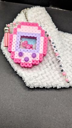 a pink and purple cell phone case sitting on top of a white blanket