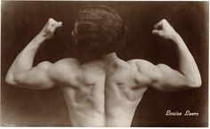 an old photo of a man with his back turned to the camera, flexing his muscles