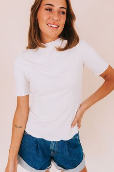 Show off your flirty side with our Beautiful Spirit Top! Made with ribbed fabric and detailed with scalloped edges, this top will add a touch of playfulness to any outfit. Complete with a mock neckline, it's the perfect balance of chic and fun. Details Ribbed Scalloped edges Mock neckline Sizing Approximate measurements: SIZE LENGTH BUST Small 23" 34" Medium 23.5" 36" Large 24" 38" XLarge 25" 42" Fabric has stretchModel is 5’10 wearing small Material 65% Rayon 30% Polyester 5% SpandexHand wash c Chic Ribbed Fitted Mock Neck Top, Chic Ribbed Turtleneck Tops, Chic High Neck Ribbed Tops, Chic Ribbed High Neck Top, Stretch Turtleneck Top With Ribbed Neckline, Spring Ribbed Mock Neck Top For Layering, Chic Stretch Ribbed Mock Neck Top, Trendy Fitted Ribbed Mock Neck Top, Stretch Ribbed Mock Neck Top