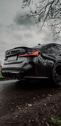 a black car parked on the side of a road