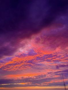 the sky is purple and pink with clouds