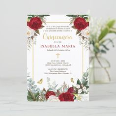 a red and white floral wedding card with gold foil on the front, featuring roses